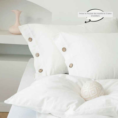 Parure lit gros plan taies oreiller boutons